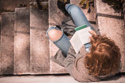 redhead-female-with-opened-book-stone-stair