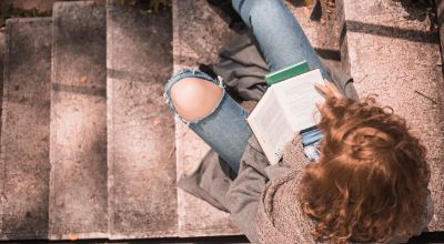 redhead-female-with-opened-book-stone-stair